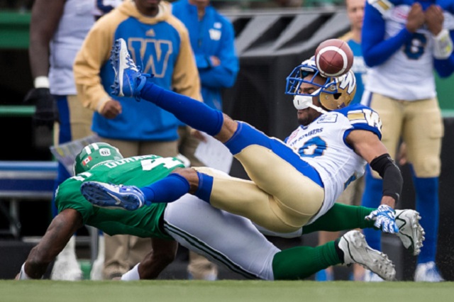 Former Winnipeg Blue Bombers defensive back Johnny Adams drops an interception after being hit by Darian Durant of the Saskatchewan Roughriders during this year's Labour Day Classic.