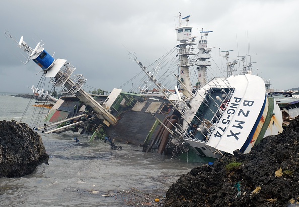 A general view shows an overturned fishing boat in the aftermath of super typhoon Meranti, at Sizihwan in Kaohsiung on Sepember 15, 2016.
Parts of Taiwan came to a standstill on September 14 as super typhoon Meranti brought the strongest winds in 21 years, while China issued a red alert for waves as the storm bore down on the mainland. S.