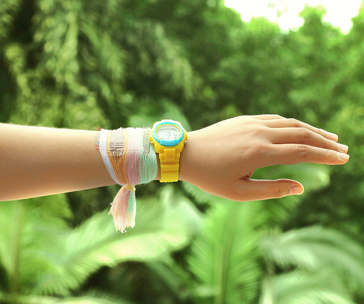 A bracelet made from fabric woven with special energy-harvesting strands that collect electricity from the sun and motion.
