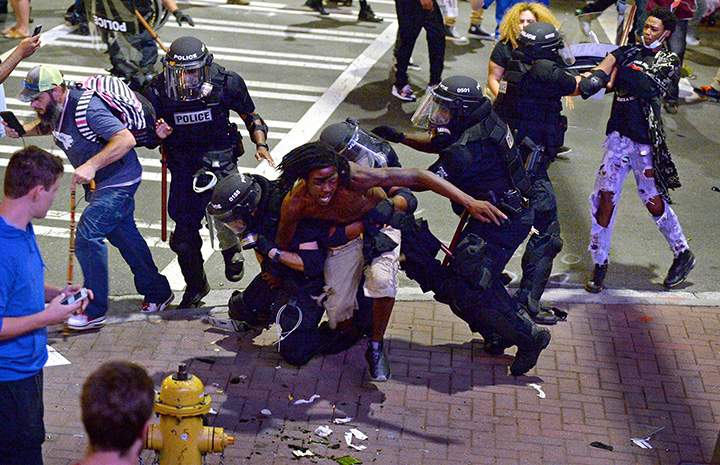 A protester is taken into custody by Charlotte-Mecklenburg police officers in North Carolina on Wednesday, Sept. 21, 2016.