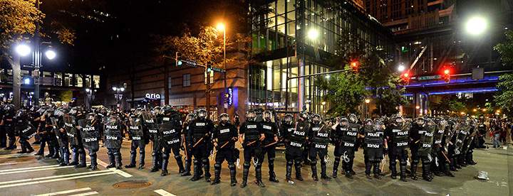 CMPD officers in riot gear block the intersection near the Epicentre in Charlotte, N.C. Wednesday, Sept. 21, 2016.