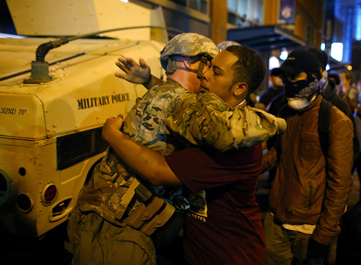 A U.S. National guard soldier accepts a hug from protester as people march through downtown to protest the police shooting of Keith Scott in Charlotte, North Carolina, September 22, 2016.