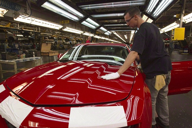 A worker checks the paint on a Camaro at the General Motors plant in Oshawa, Ont., June 10, 2011. Autoworkers' union Unifor is waiting for a new production commitment from GM.