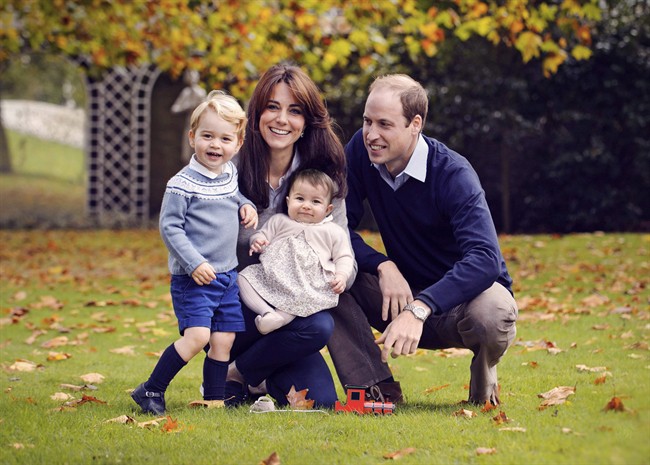 This photo released by Kensington Palace on Friday Dec. 18, 2015 shows The Duke and Duchess of Cambridge with their two children, Prince George and Princess Charlotte, in a photograph taken late October 2015 at Kensington Palace in London. 