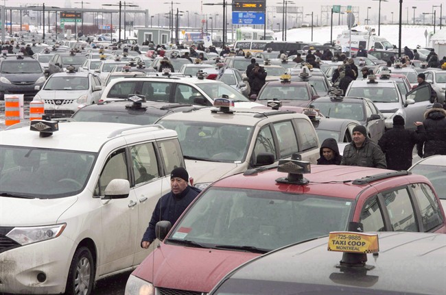 In this file photo, taxi drivers take part in an anti-Uber protest at Trudeau Airport in Montreal on February 10, 2016.
