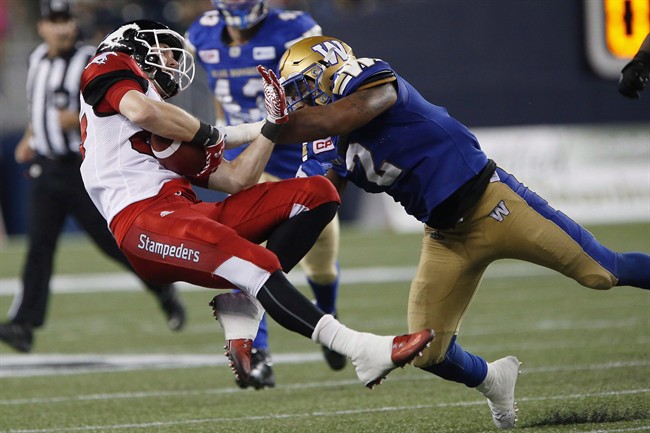 Former Winnipeg Blue Bombers linebacker Khalil Bass tackles Calgary Stampeders' Simon Charbonneau-Campeau during the second half of a CFL game in Winnipeg on July 21, 2016. 