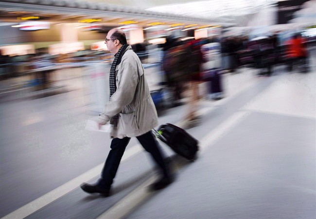 A man carries his luggage at Pearson International Airport in Toronto on December 20, 2013.