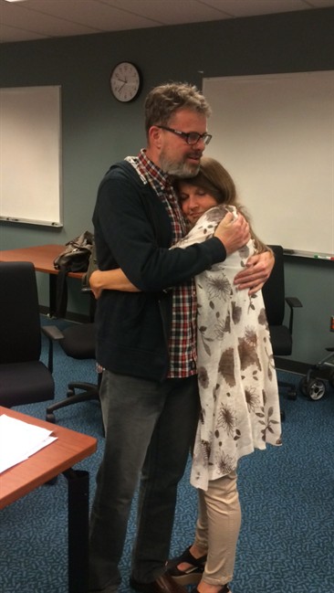Kevin Garratt embraces his wife Julia at the Vancouver International Airport on Thursday, Sept. 15, 2016. Kevin Garratt was jailed in China for more than two years and accused of spying but has now been released and is back in Canada. THE CANADIAN PRESS/HO, James Zimmerman