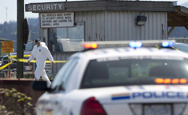 Members of the RCMP are seen outside the Western Forest Products mill in Nanaimo, B.C., on April 30, 2014. 