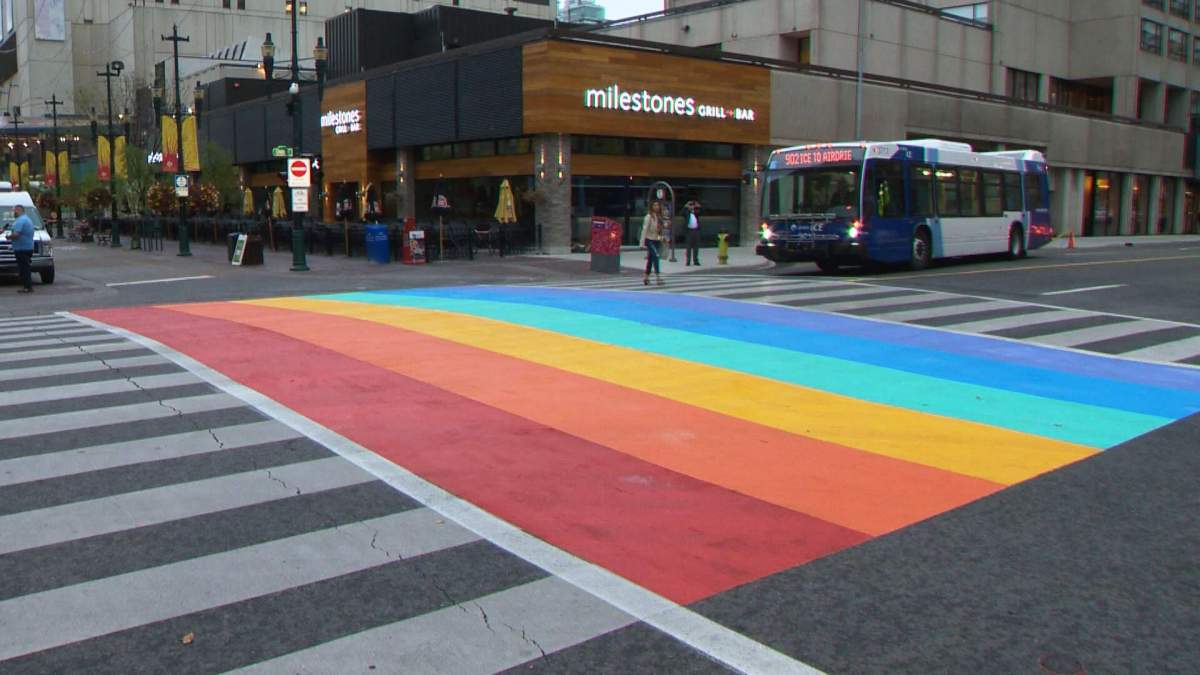 A rainbow crosswalk painted at the intersection of 8 Avenue and Centre Street, near the Calgary Tower.