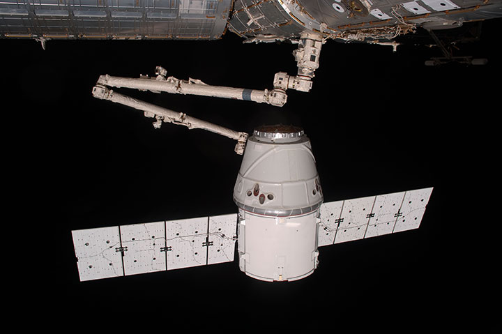 Canadarm2 grabs SpaceX’s Dragon capsule in its first visit to the International Space Station.