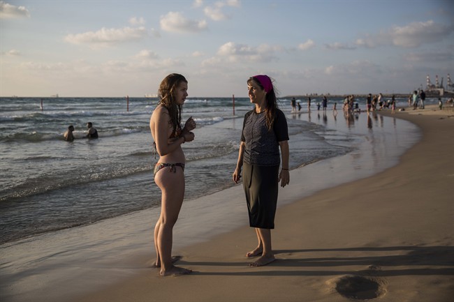 In this photo made on Thursday, Sep. 1, 2016, an Israeli Jewish woman wears modest swimsuite on the beach near the port city of Ashdod, Israel. France's burkini controversy is boosting the bottom line for Israeli makers of modest swimwear. Israel, home to large populations of conservative Jewish and Muslim women, has cultivated a local industry of modest swimsuits, and the full-body outfits that have caused uproar in France have been a common sight on Israeli beaches for several years.