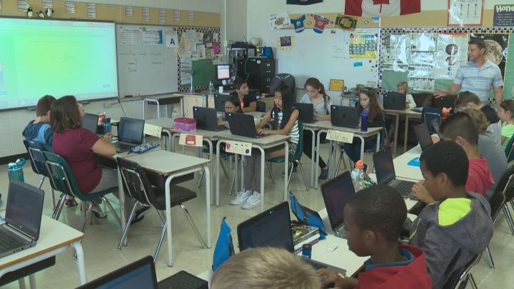 Kids work during class at St. Maria Goretti school in northeast Edmonton. 