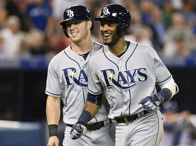 Tampa Bay Rays' Corey Dickerson, left, congratulates teammate Alexei Ramirez on his three-run home run against the Toronto Blue Jays during fifth inning American League baseball action in Toronto on Tuesday, Sept.13, 2016.