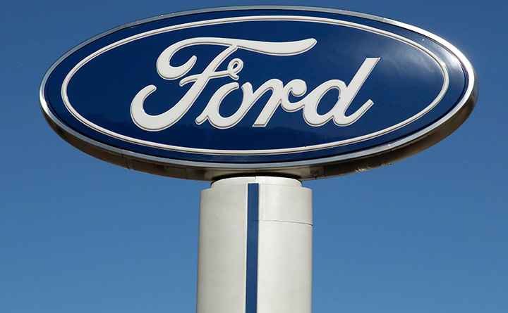 This Tuesday, Oct. 25, 2011, file photo shows a Ford sign at the Salem Ford dealership in Salem, N.H. 