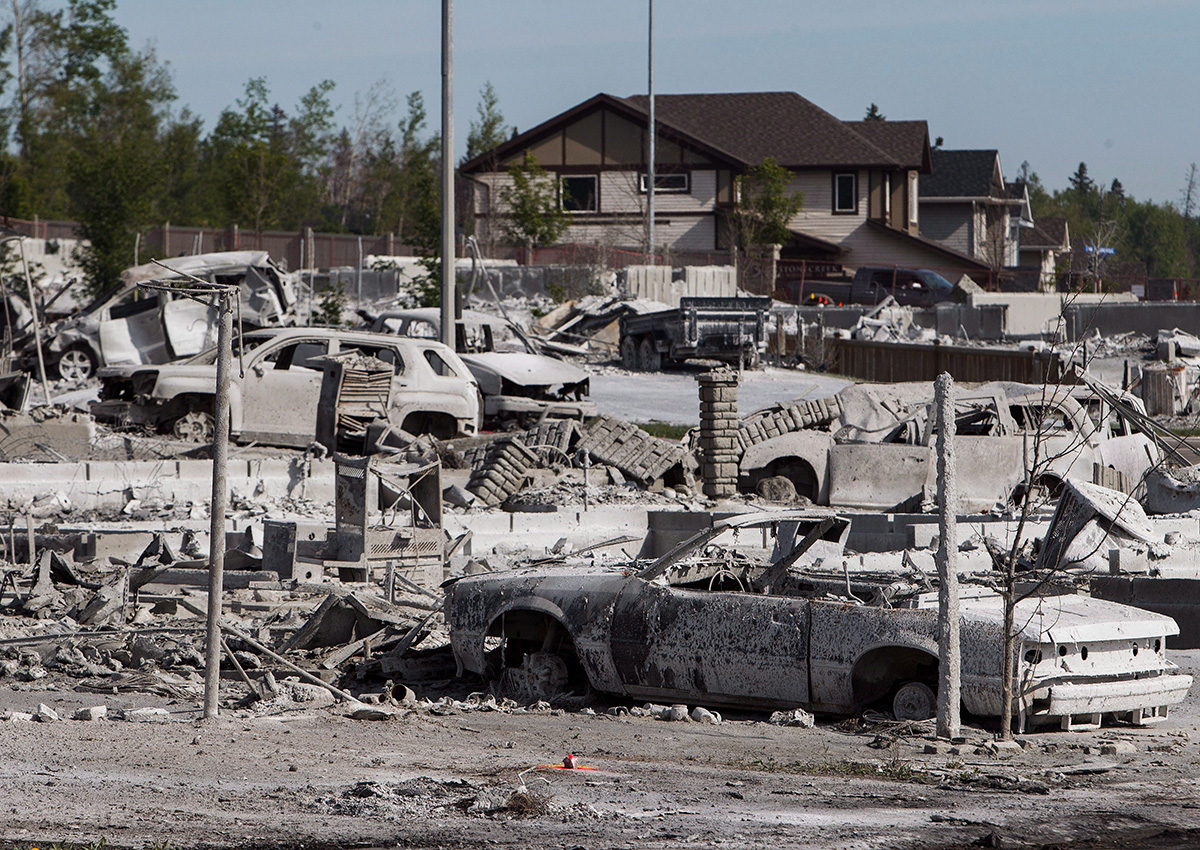 Burned-out homes and vehicles are seen in the Timberlea neighbourhood as residents re-enter fire-ravaged Fort McMurray, Alta., on Thursday, June 2, 2016. 