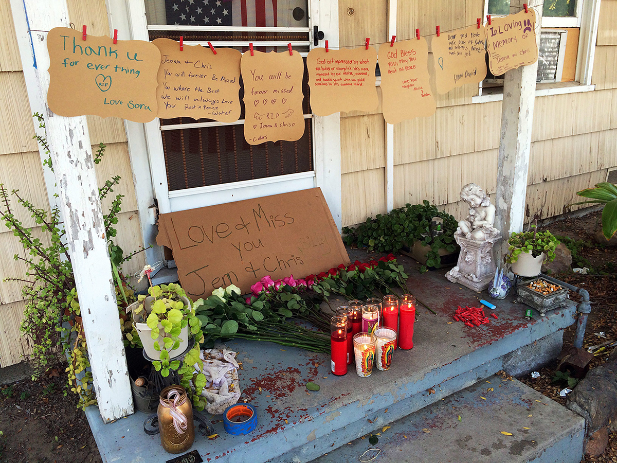 A makeshift memorial is created on the front porch of the home where three adults were found dead Saturday, Sept. 24, 2016, in Fullerton, Calif., Sunday, Sept. 25, 2016. 