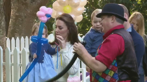 Princess Charlotte gets a balloon animal made for her and attempts to bonk the entertainer on the head. That’s when Prince George steals it, but Princess Charlotte doesn’t seem to mind.