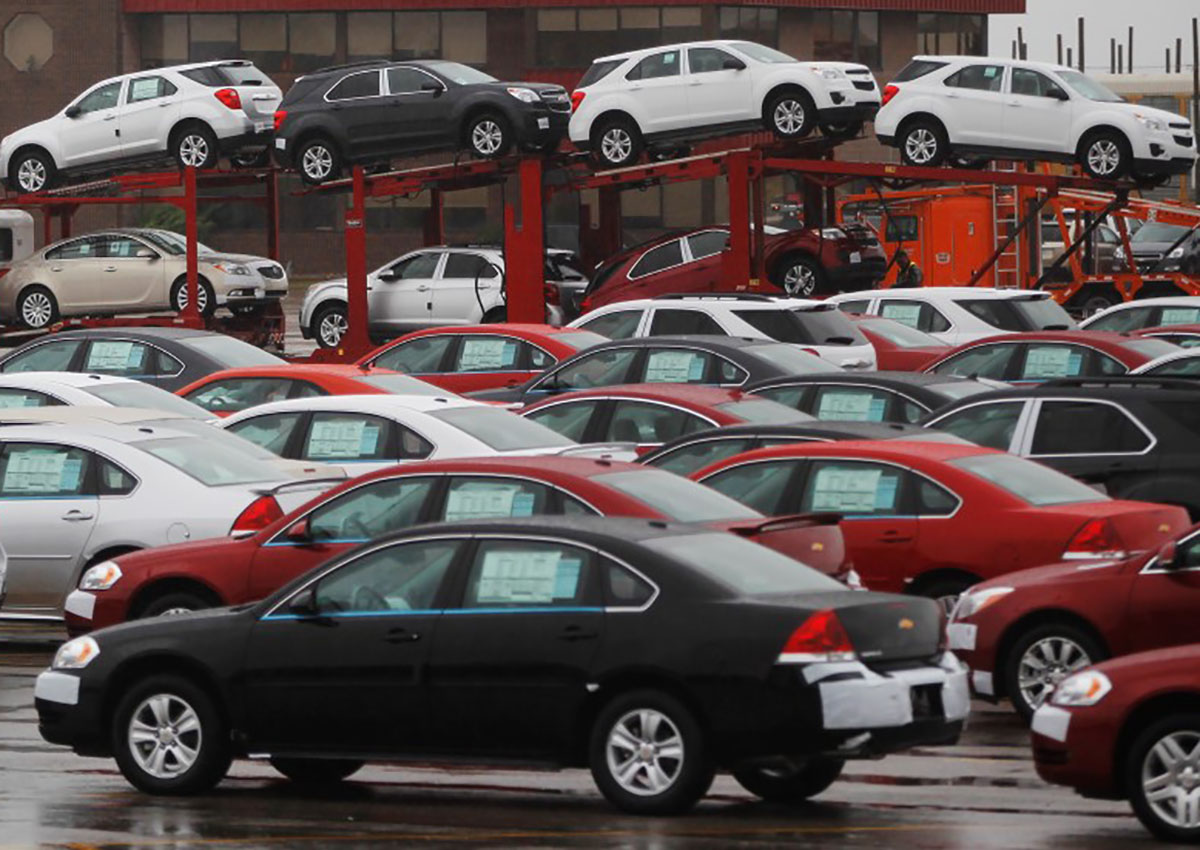 Newly built cars sit in a shipping lot near  General Motors Car assembly plant in Oshawa, June 1, 2012.