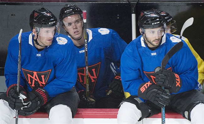 Team North America players, from left, Sean Couturier, Connor McDavid and Vincent Trocheck look on from the bench during training camp in Montreal, Monday, September 5, 2016, ahead of the 2016 World Cup of Hockey competition. 