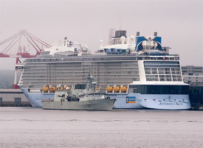 FILE: The massive cruise ship Anthem of the Seas, operated by Royal Caribbean International, dwarfs HMCS Ville de Québec, a Halifax-class frigate, in Halifax on Thursday, Sept. 1, 2016.