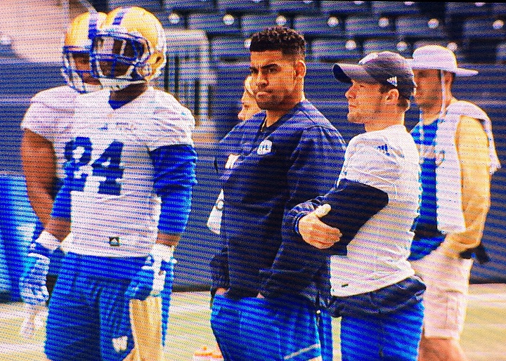 Winnipeg Blue Bombers running back Andrew Harris and receiver Ryan Smith watch Tuesday's practice. 