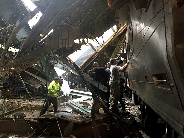 Train personnel survey the NJ Transit train that crashed in to the platform at the Hoboken Terminal September 29, 2016 in Hoboken, New Jersey.