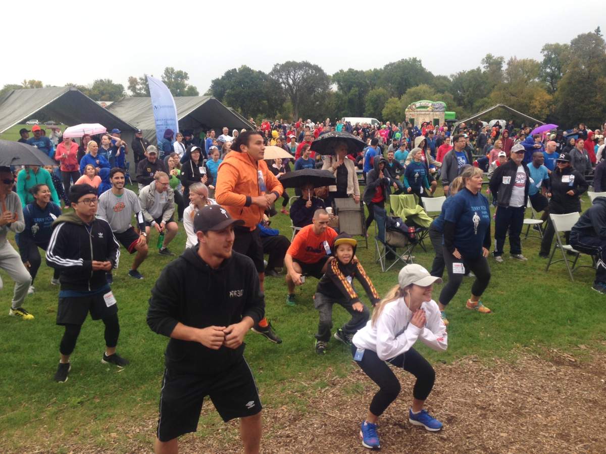 Runners, including Manitoba MLAs Wab Kinew and Kevin Chief warm up before the run.