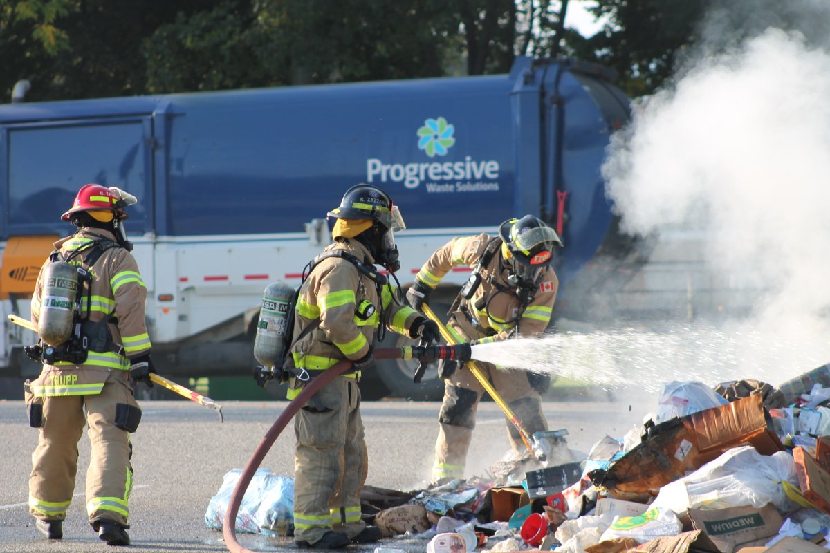 Penticton fire crews dousing a garbage fire.