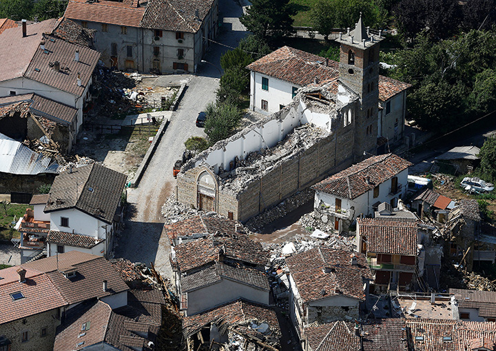 Collapsed houses and a church are seen in Villa San Lorenzo, a village near Amatrice after an earthquake hit central Italy, September 1, 2016.
