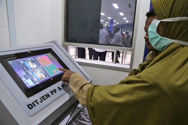 Indonesian Health Ministry officials operate a thermal scanner used to monitor ferry passengers arriving from Singapore at the arrival hall of Batam Center International Port in Batam, Indonesia, Thursday, Sept. 1, 2016. Indonesia is screening travelers from neighboring Singapore for the mosquito-borne Zika virus as the city-state reports a growing number of infections and its first case of a pregnant woman testing positive. (AP Photo/M. Urip).