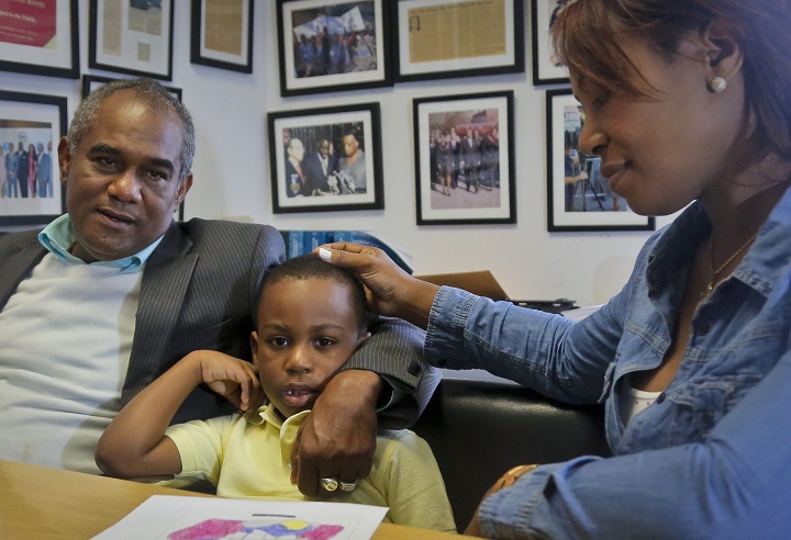 Raphael and Maribel Martinez comfort their son Andy after a press conference at their lawyer's office, Friday Sept. 30, 2016, in New York.  Maribel Martinez has filed a lawsuit against JetBlue Airways for mixing up Andy with another boy and flying him to the wrong city. 