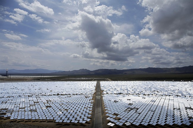 FILE - This Aug. 13, 2014 photo, shows an array of mirrors at the Ivanpah Solar Electric Generating site in Primm, Nev. 