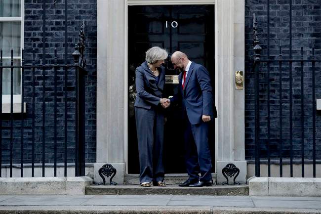 British Prime Minister Theresa May and the President of the European Parliament Martin Schulz perform a posed handshake for the media before their talks at 10 Downing Street in London, Thursday, Sept. 22, 2016.