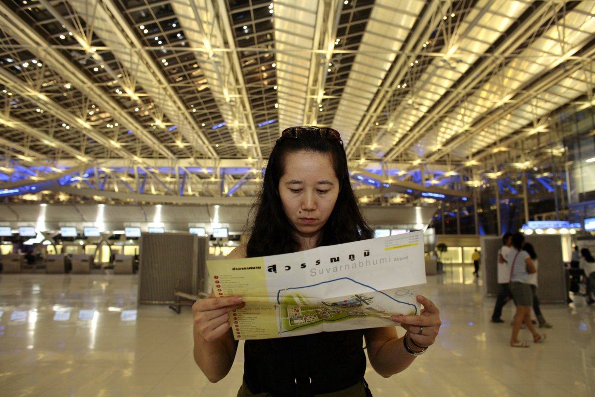 A woman reads the map while  at the domestic check in counter of the new Suvarnabhumi Airport in Bangkok, Thailand. 