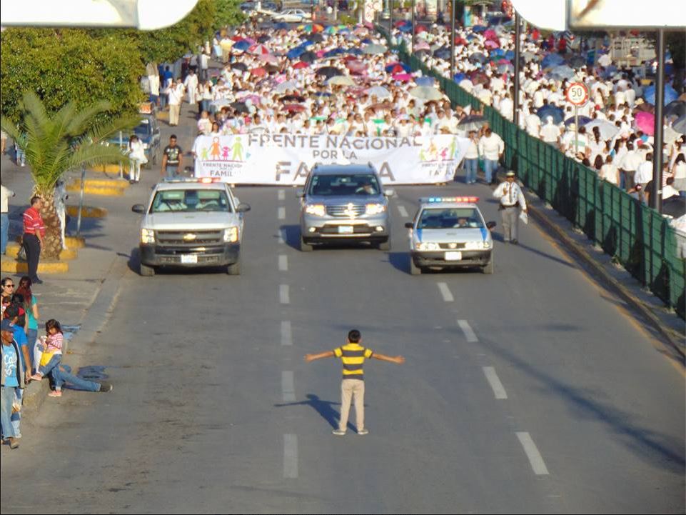 A photo of a boy standing in front of thousands of anti-LGBTQ protesters in Mexico, as captured by Twitter user @ZackFord. 