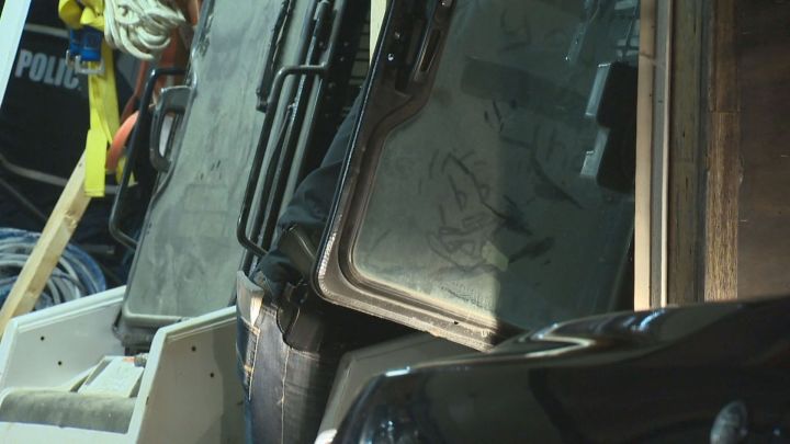 Police officers search through a Mill Woods garage after discovering what they said they believe is an improvised explosive device. Sept. 6, 2016.