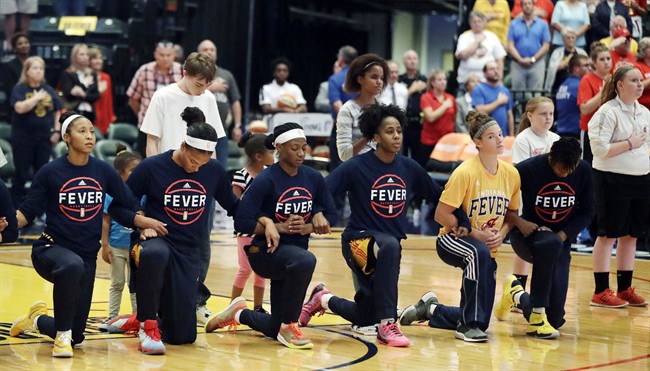 Members of the Indiana Fever kneel during the playing of the national anthem before the start of of a first round WNBA playoff basketball game, against the Phoenix Mercury, Wednesday, Sept. 21, 2016, in Indianapolis. 