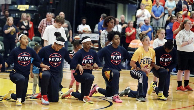Members of the Indiana Fever kneel during the playing of the national anthem before the start of of a first round WNBA playoff basketball game, against the Phoenix Mercury, Wednesday, Sept. 21, 2016, in Indianapolis. 