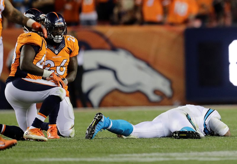 Carolina Panthers quarterback Cam Newton (1) lies on the turf after a roughing the passer penalty on Denver Broncos free safety Darian Stewart (26) during the second half of an NFL football game, Thursday, Sept. 8, 2016, in Denver. 