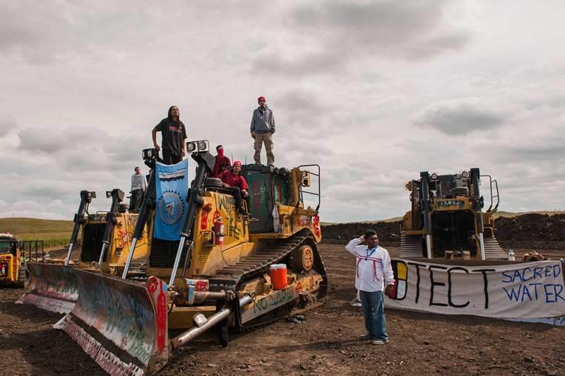 Protesters stand on heavy machinery after halting work on the Energy Transfer Partners Dakota Access oil pipeline near the Standing Rock Sioux reservation near Cannon Ball, North Dakota, U.S. September 6, 2016.