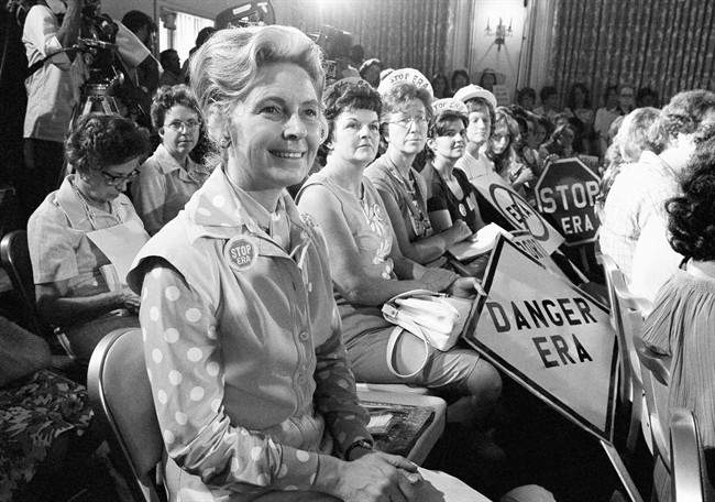 In this Aug. 10, 1976, file photo, women opposed to the Equal Rights Amendment sit with Phyllis Schlafly, left, national chairman of Stop ERA, at hearing of Republican platform subcommittee on human rights and responsibilities in a free society in Kansas City, Mo.
