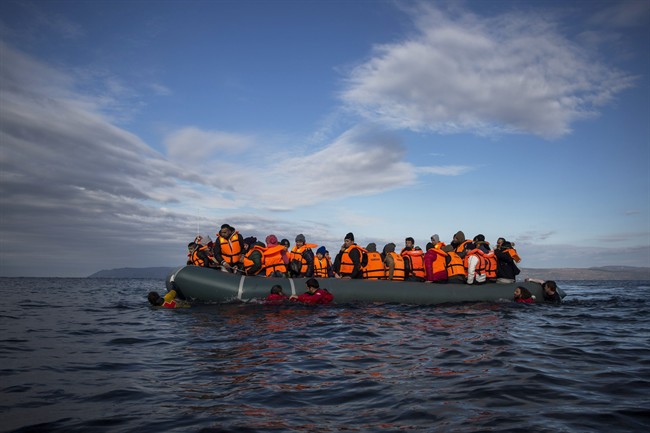 In this Dec. 3, 2015 file photo, refugees and migrants arrive on an inflatable vessel from the Turkish coast to the northeastern Greek island of Lesbos. The question of what to do about the world‚Äôs 65.3 million displaced people takes center stage at the United Nations General Assembly Monday, Sept. 19, 2016, when leaders from around the globe converge on New York for the first-ever summit on Addressing Large Movements of Refugees and Migrants. (AP Photo/Santi Palacios, File).