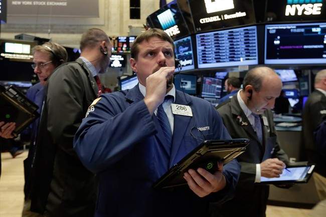 In this Monday, Sept. 26, 2016 photo, a trader works on the floor of the New York Stock Exchange.  