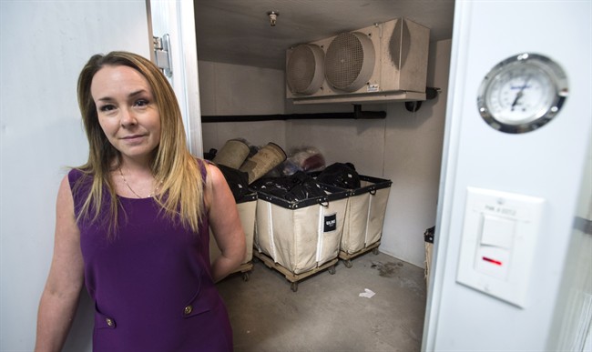 Melanie Sanche, head of sanitation for Montreal's public housing authority, stands at the threshold of a freezer room specially designed to kill the bedbugs on a resident's items, in Montreal on Monday, August 22, 2016. The freezer is kept at -22 degrees Celsius, which takes four days to kill all bed bugs on a person's belongings. Sunday, Sept. 4, 2016.