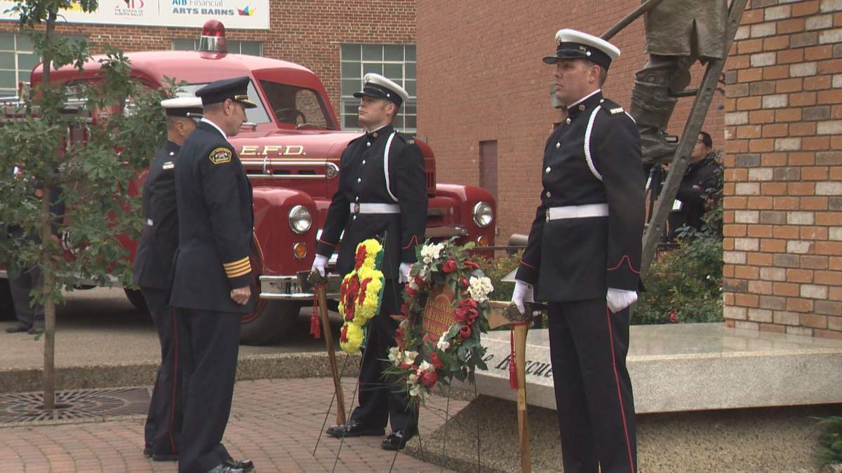 Firefighters lay a wreath at Edmonton’s Firefighter Memorial Plaza