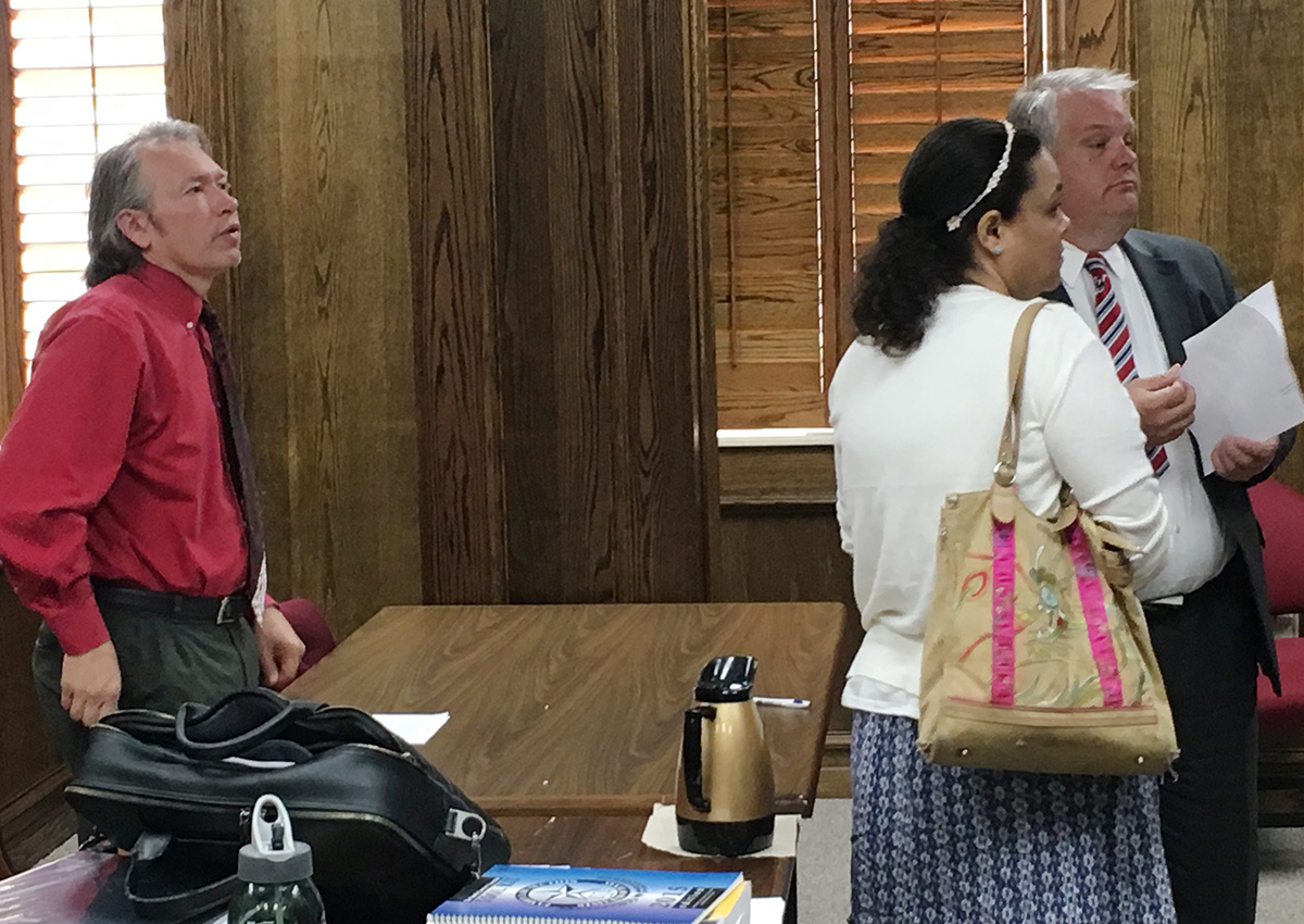 William A. Rembis, left, and his wife Claire, center, accompanied by William Rembis' court-appointed attorney Mark Skelton, right, talk with a judge who ruled the couple's 11 children will remain in the state's custody for now, Tuesday, Sept. 20, 2016, in Lubbock, Texas. 