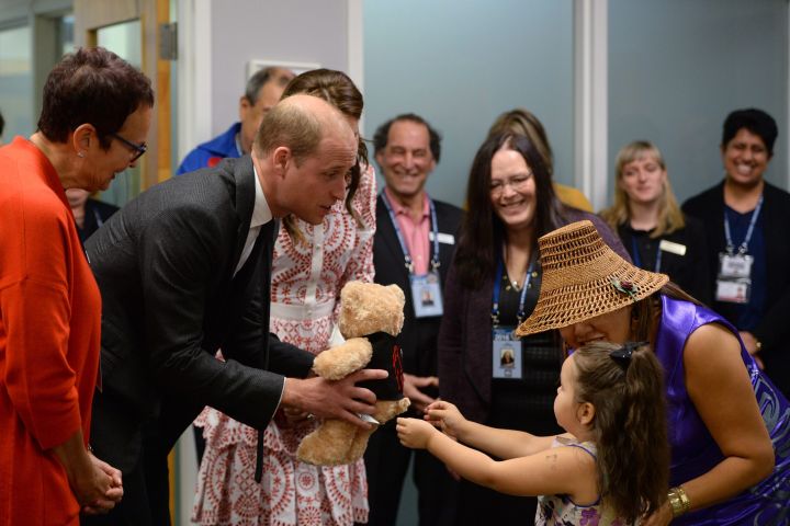 Britain’s Prince William receives a teddy bear from five-year-old Hailey Cain during a tour of Sheway, a centre that provides support for native women, during a visit to Vancouver, B.C., Sunday, Sept. 25, 2016.