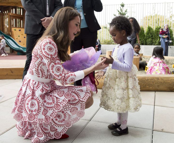 The Duchess of Cambridge receives flowers from a little girl at the Immigration Services Society in Vancouver, B.C., Sunday, Sept 25, 2016.