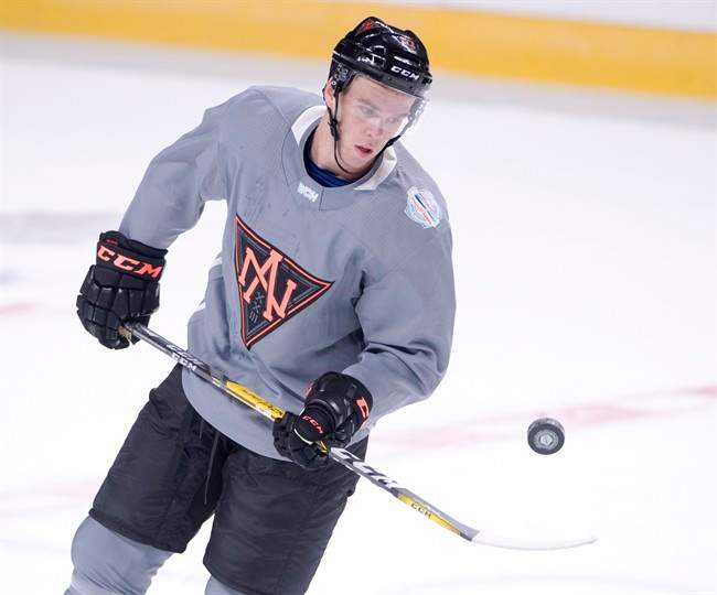 Team North America forward Connor McDavid bounces a puck during the team's World Cup hockey practice Wednesday, September 7, 2016 in Montreal.